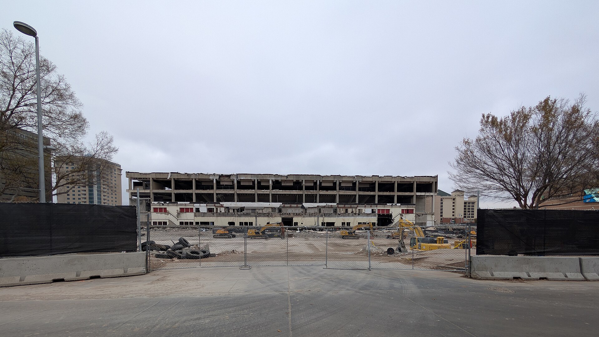 Fenced downtown Oklahoma City lot with excavators clearing the site for the new arena